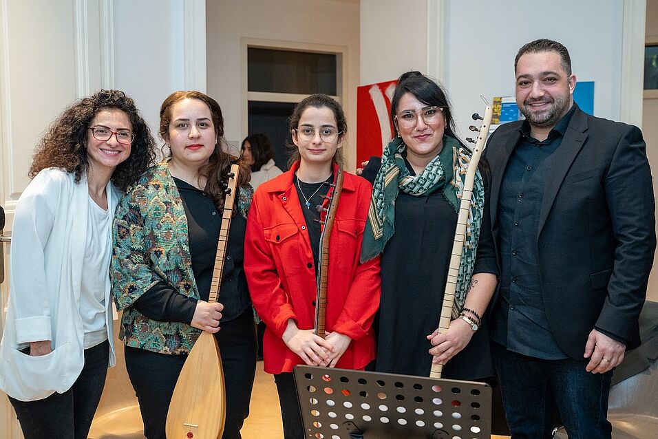 Opens in new tab. Group photo of Prof. Handan Aksünger-Kizil with Seda Erol and the musicians