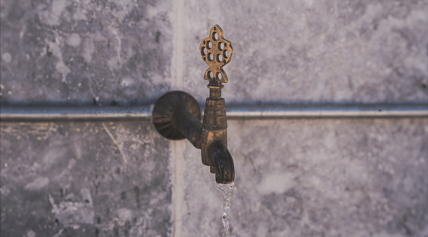 An ornate tap on a wall