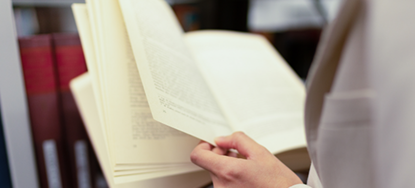 A close-up of a book being held in the hand