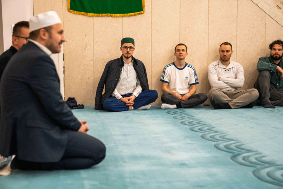 Enlarge in new tab: Participants sitting in the prayer room