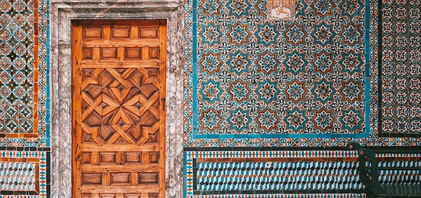 Colourful wall tiles and wooden door
